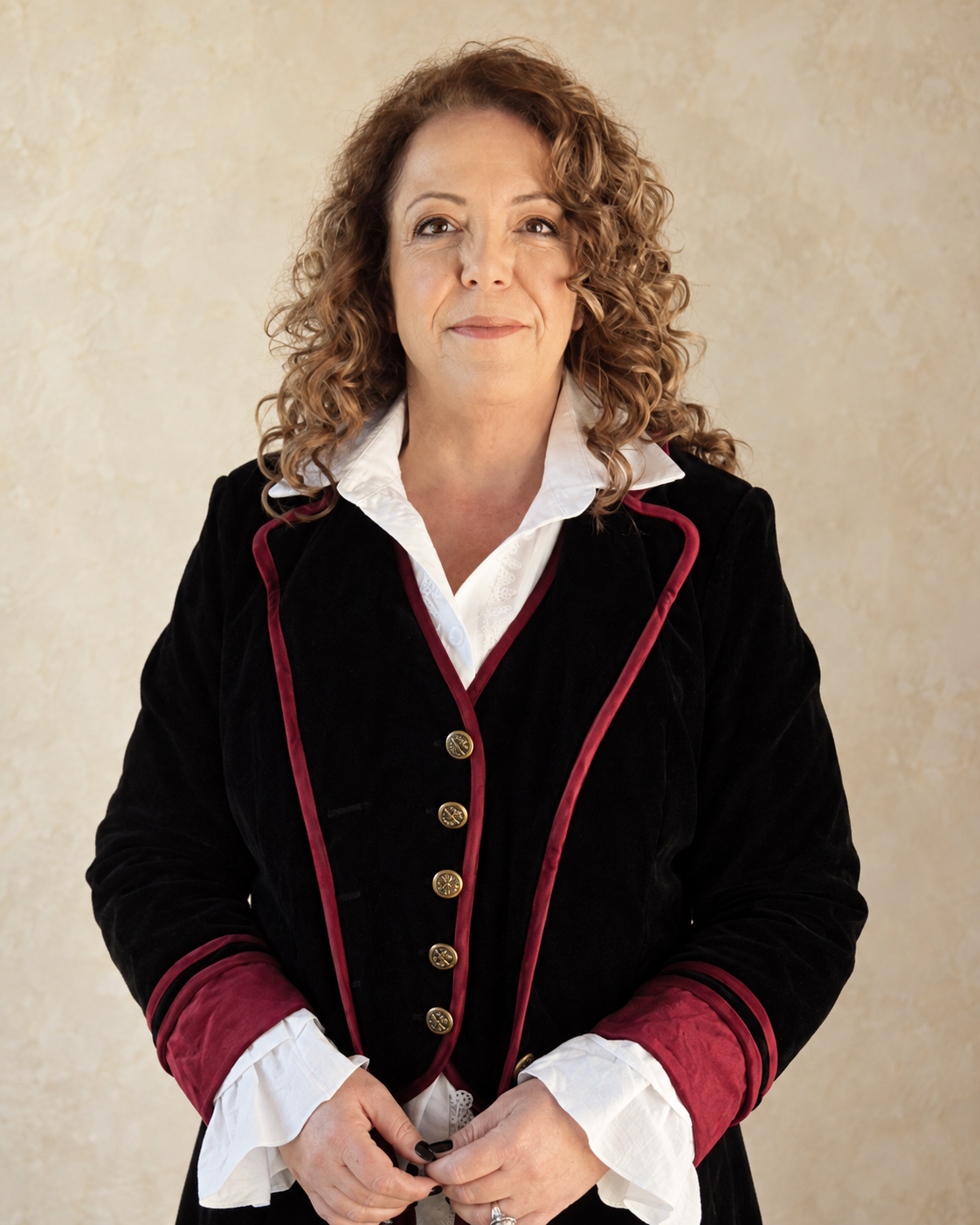 Leonie Stanley in a black and burgundy velvet coat